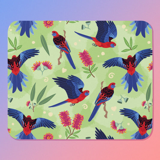 Mouse pad with crimson rosella parrot design on a blue-pink gradient background