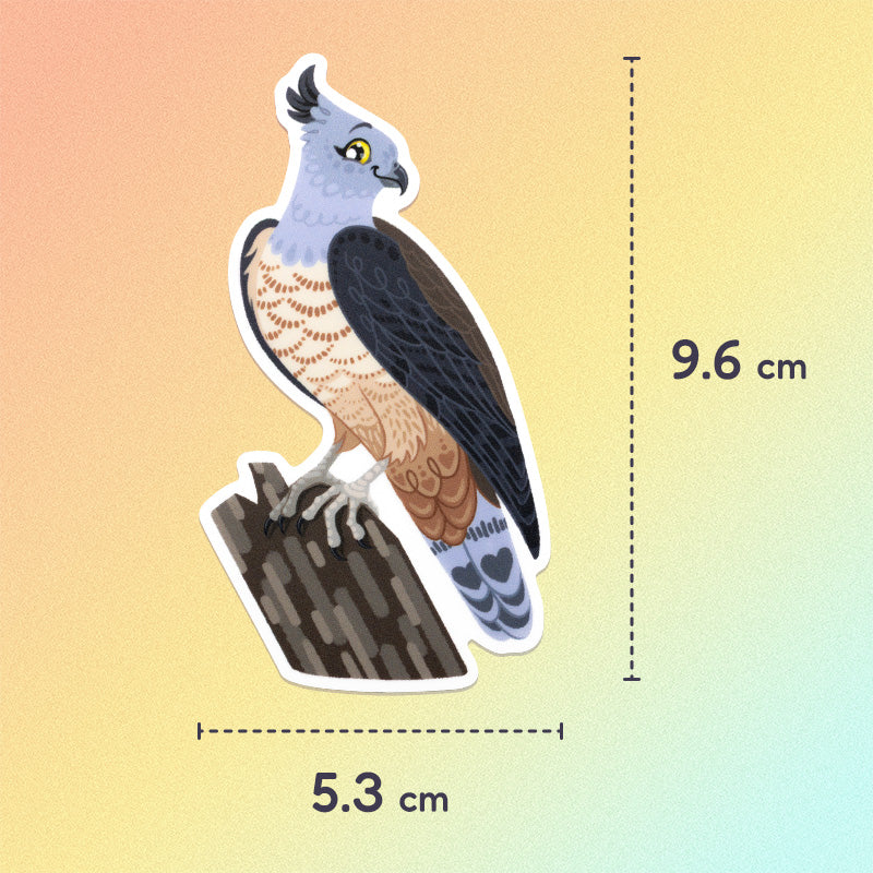 5.3x9.6cm colourful sticker of a pacific baza perched on a tree branch on an orange, yellow and aqua gradient background.