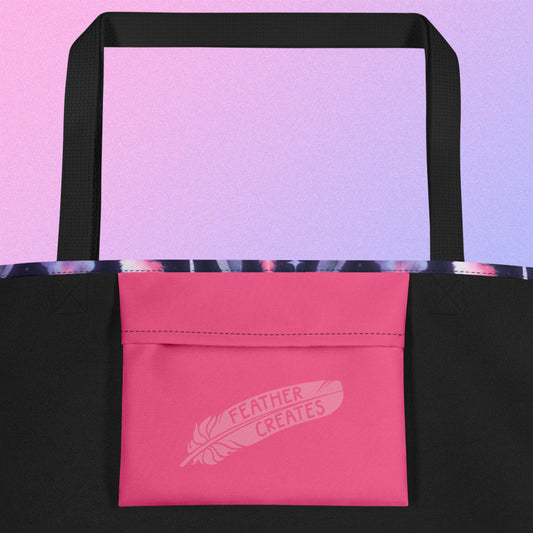 Close up of a pink fold-over pocket on the inside of a tote bag with a black strap on a gradient purple background.