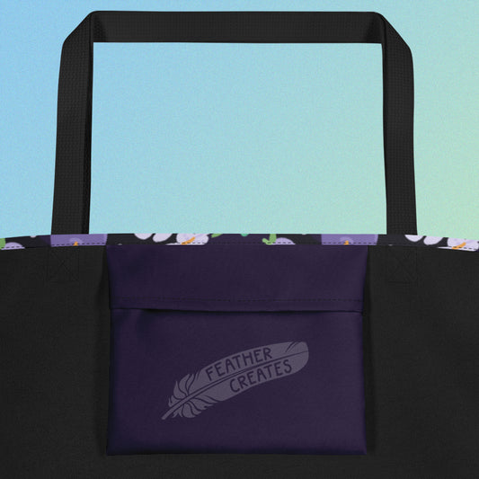 Close up of a dark purple fold-over pocket on the inside of a tote bag with a black strap on a gradient blue and green background.