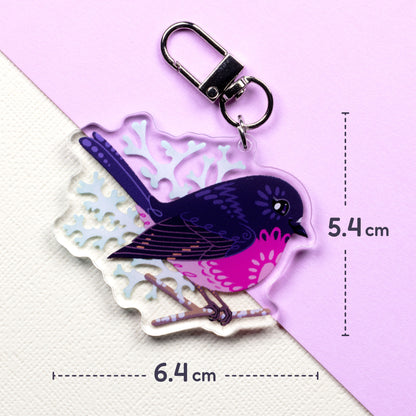 6.4x5.4cm double-sided acrylic keychain of male & female pink robins sitting on a split cream and pale lilac background.