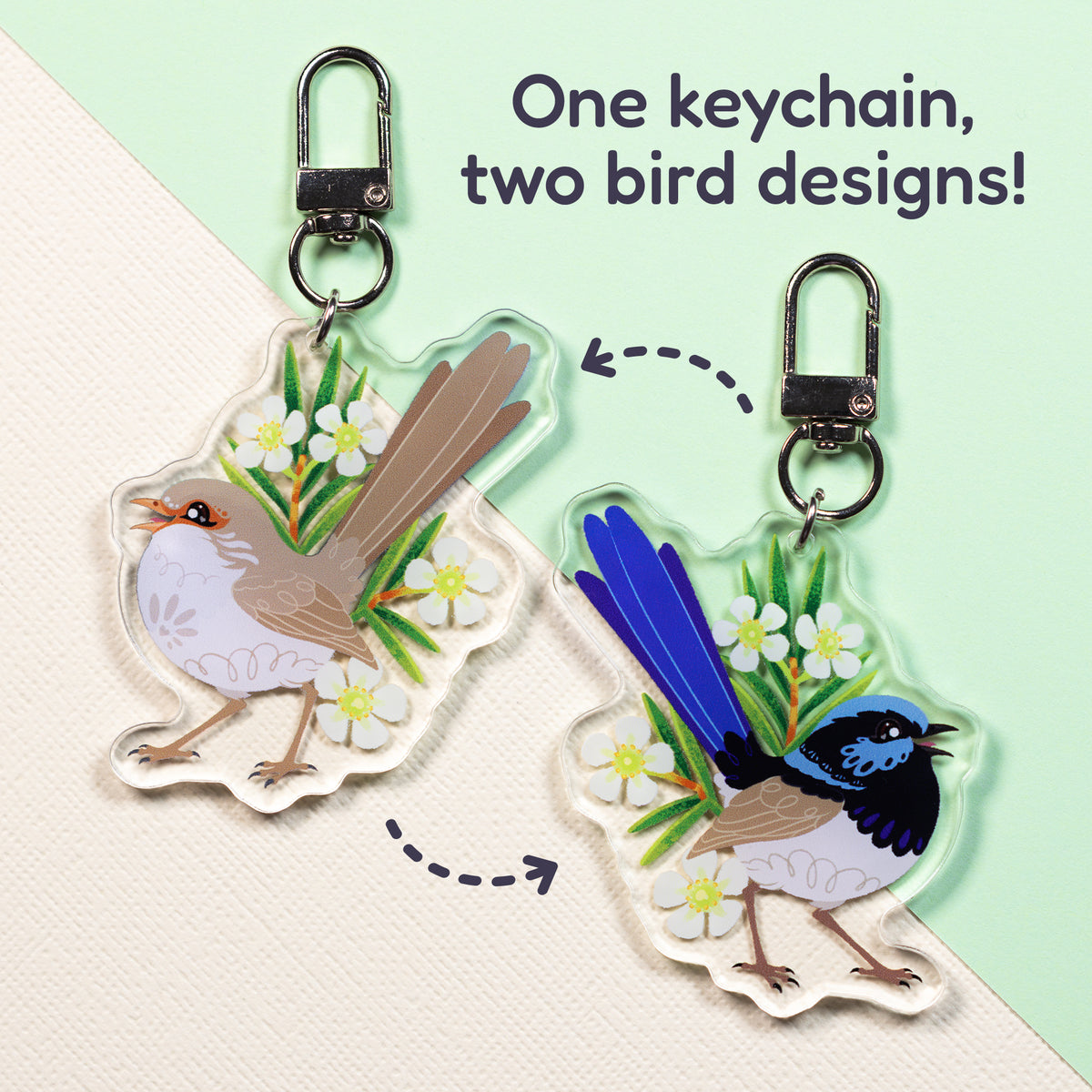 Both sides of a double-sided acrylic keychain of a male and female superb fairywren sitting on a split cream and pale green background with the text 'One keychain, two bird designs!' in the top right.