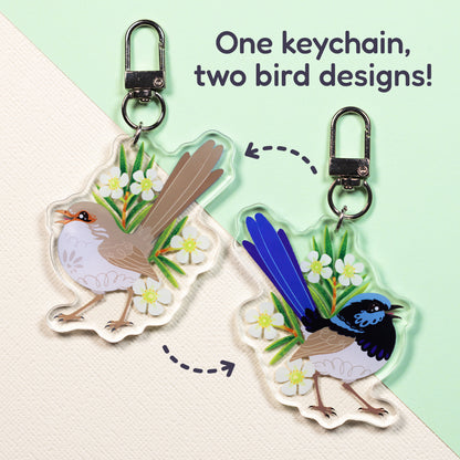 Both sides of a double-sided acrylic keychain of a male and female superb fairywren sitting on a split cream and pale green background with the text 'One keychain, two bird designs!' in the top right.