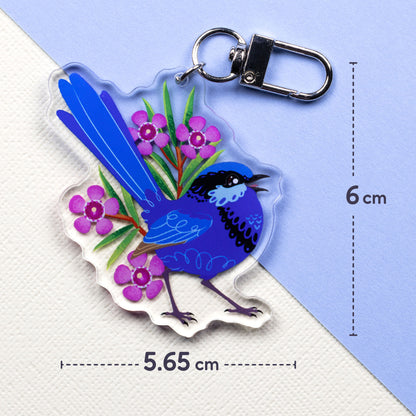 5.65 x 6cm double-sided acrylic keychain of male & female splendid fairywrens sitting on a split cream and pale blue background.