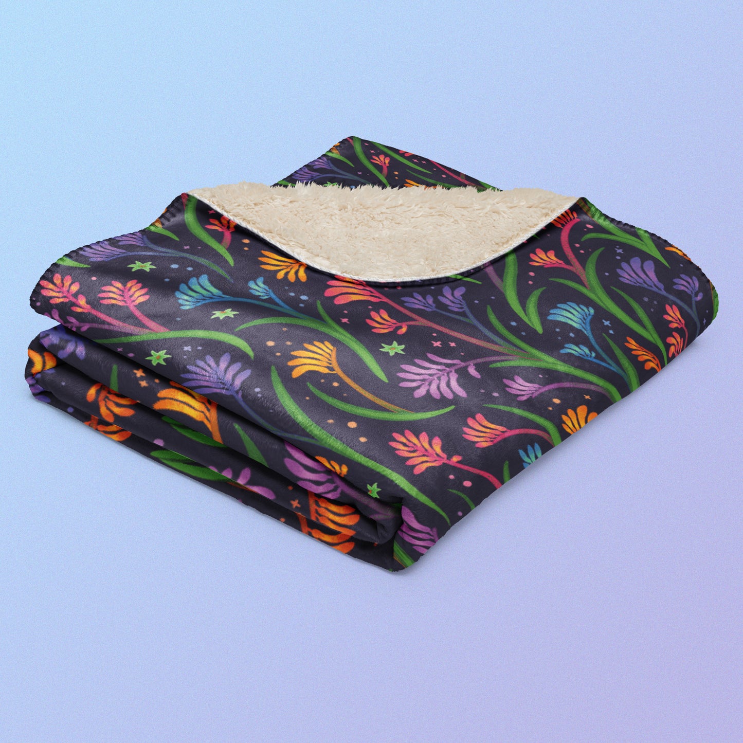 A folded rainbow kangaroo paw flower pattern blanket on a blue and purple gradient background.
