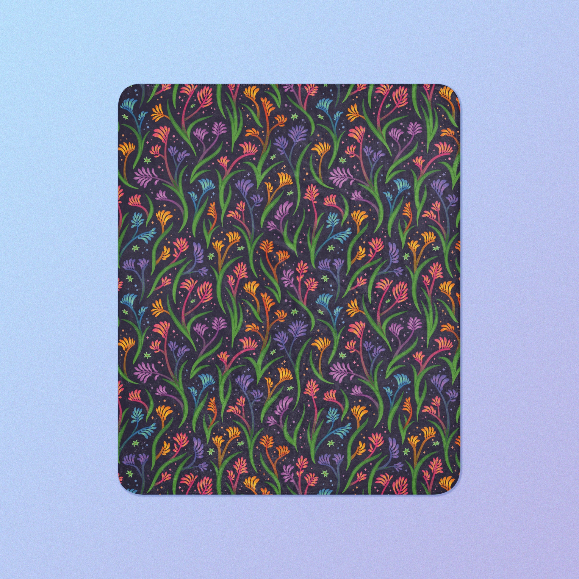 A rainbow kangaroo paw flower pattern blanket on a blue and purple gradient background.