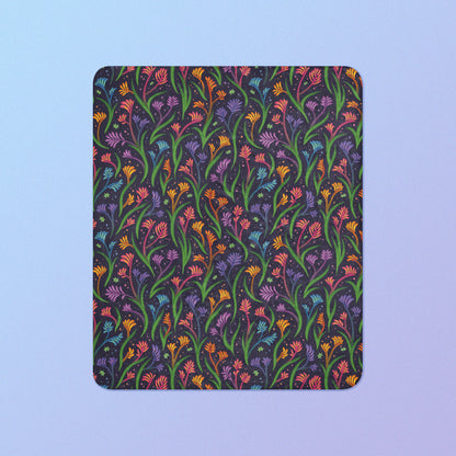 A rainbow kangaroo paw flower pattern blanket on a blue and purple gradient background.