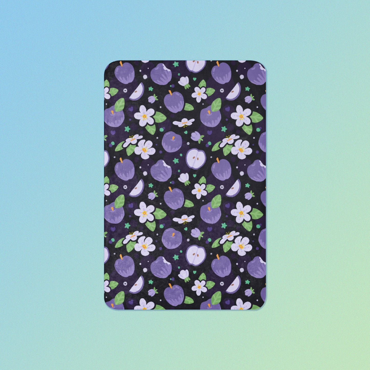 A purple apples & blossoms pattern blanket on a blue and green gradient background.