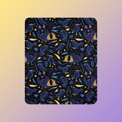 A black, blue, purple and yellow male Aussie satin bowerbird pattern blanket on a yellow and purple gradient background.