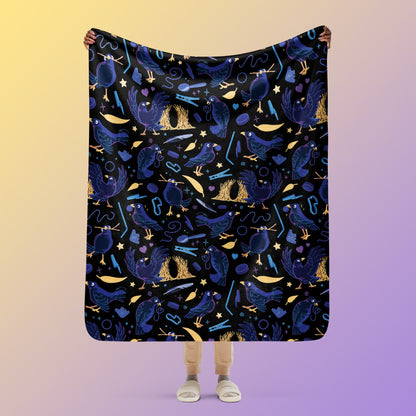 Person holding a black, blue, purple and yellow male Aussie satin bowerbird pattern blanket above their head on a yellow and purple gradient background.