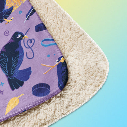 Close up detail of a folded purple, blue and yellow male Aussie satin bowerbird pattern blanket on a yellow and blue gradient background.