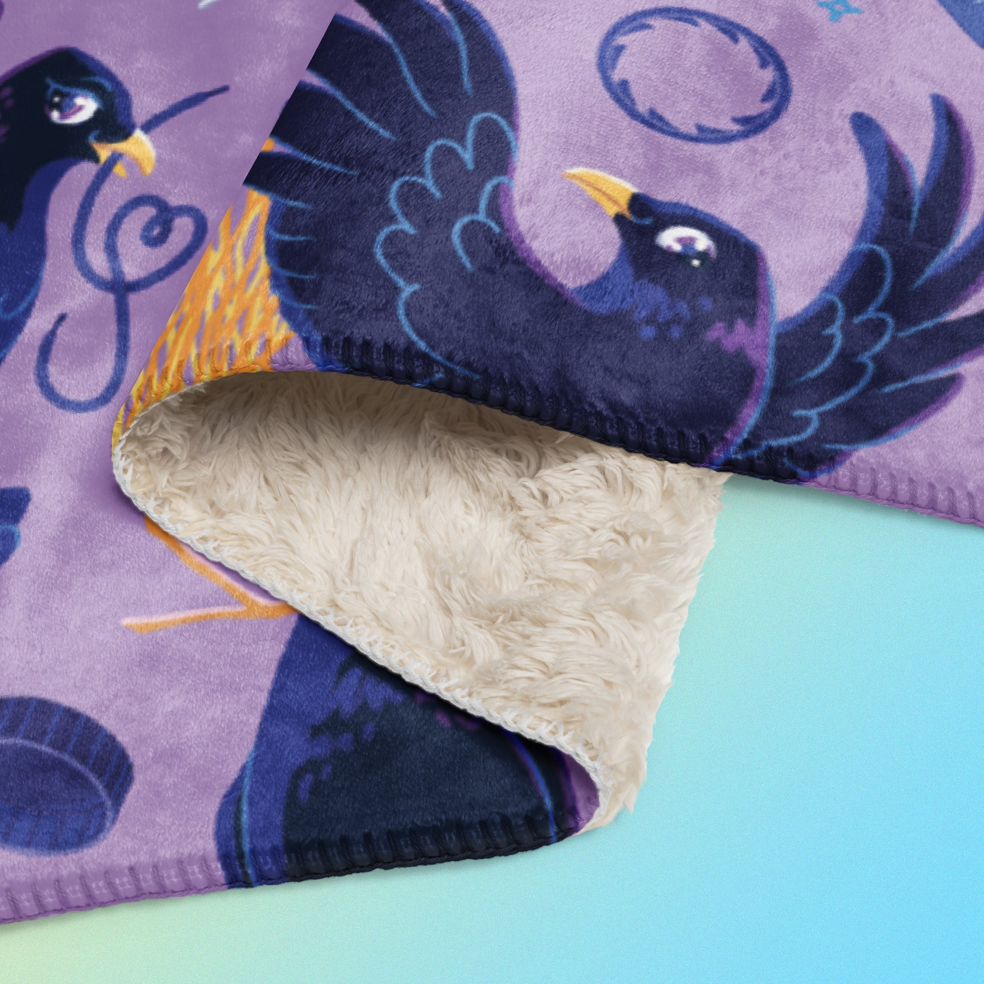 Close up detail of a folded purple, blue and yellow male Aussie satin bowerbird pattern blanket on a yellow and blue gradient background.