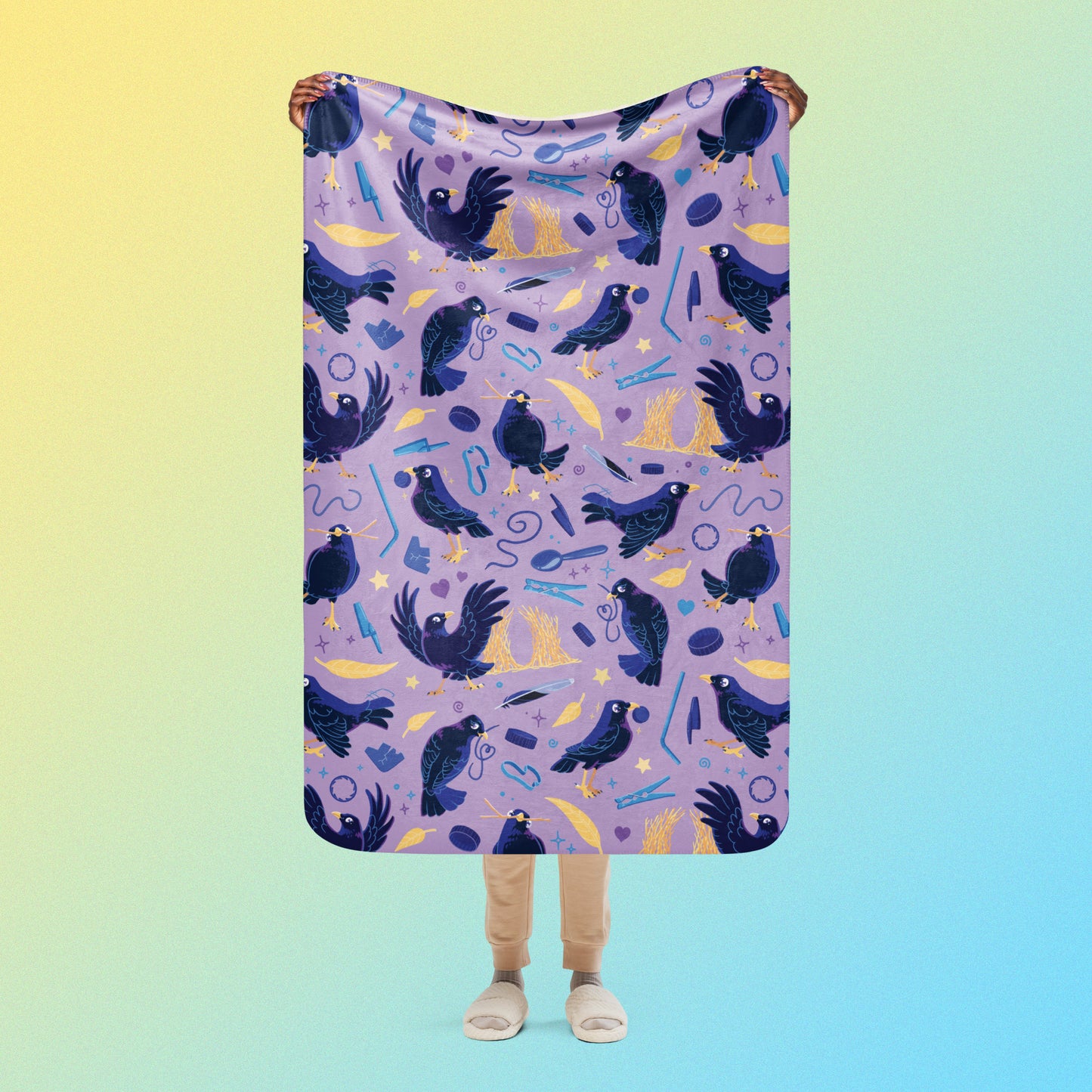 Person holding a purple, blue and yellow male Aussie satin bowerbird pattern blanket above their head on a yellow and blue gradient background.
