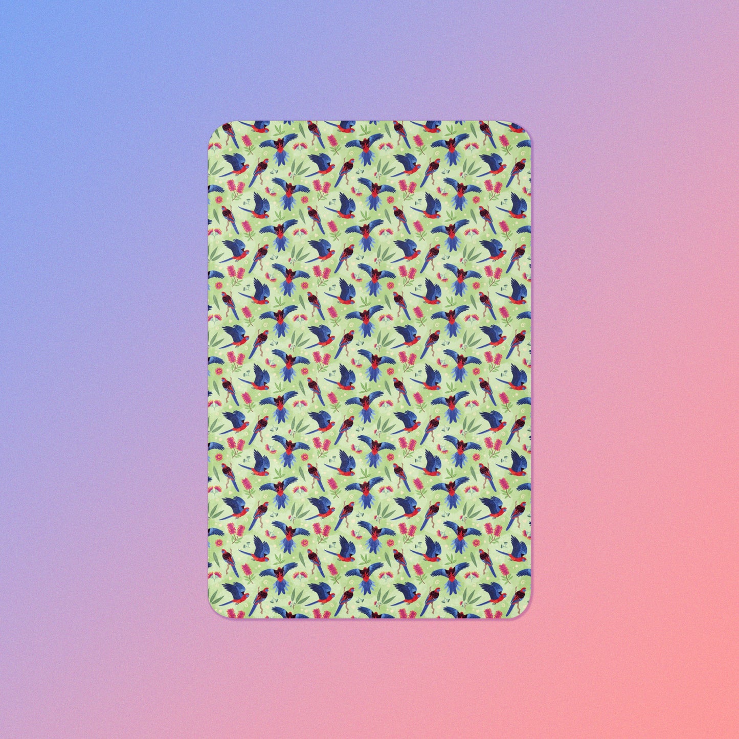 A green, red and blue crimson rosella & native Aussie plant pattern blanket on a blue and pink gradient background.