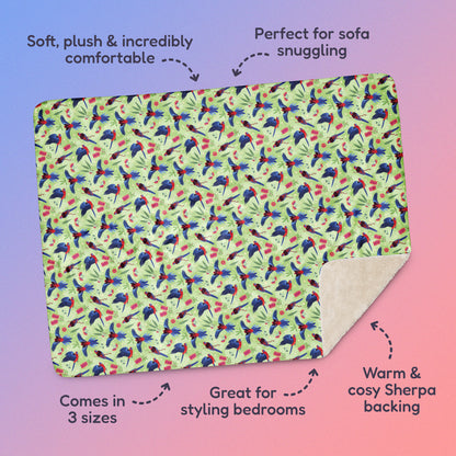 Features & benefits ('Soft, plush & incredibly comfortable', 'Perfect for sofa snuggling', 'Comes in 3 sizes', 'Great for styling bedrooms', 'Warm & cosy Sherpa backing') surrounding  a green, red and blue crimson rosella & native Aussie plant pattern blanket on a blue and pink gradient background.
