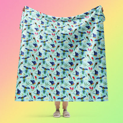 Person holding a blue, pink and green eastern rosella & native Aussie plant pattern blanket above their head on a pink, yellow and green gradient background.