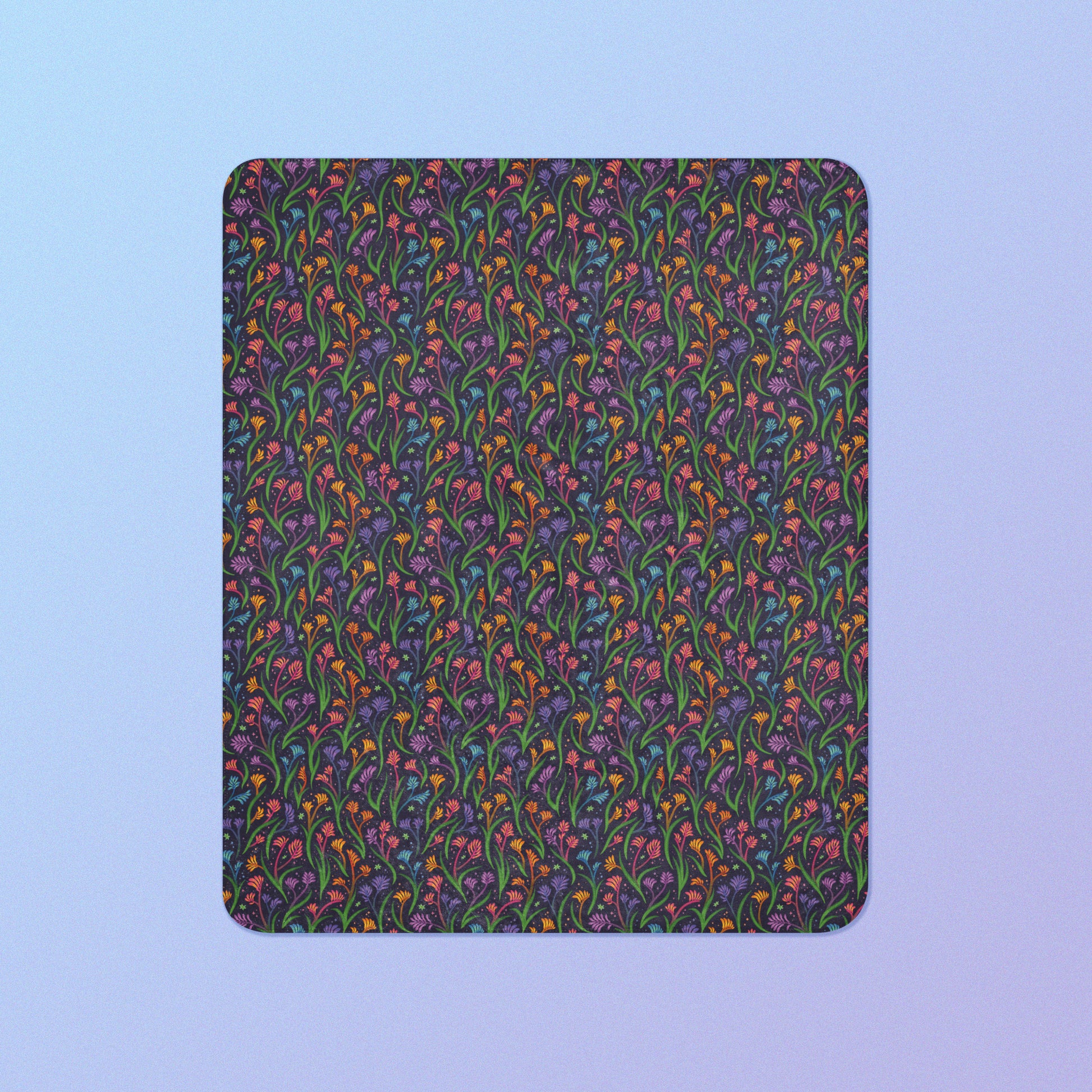 A rainbow kangaroo paw flower pattern blanket on a blue and purple gradient background.