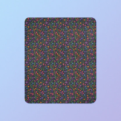 A rainbow kangaroo paw flower pattern blanket on a blue and purple gradient background.