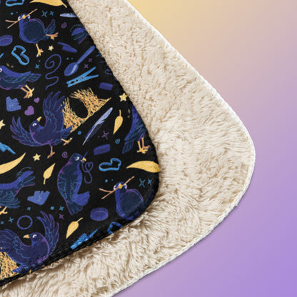 Close up detail of a folded black, blue, purple and yellow male Aussie satin bowerbird pattern blanket on a yellow and purple gradient background.
