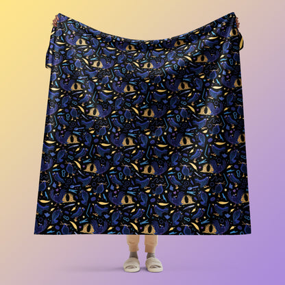 Person holding a black, blue, purple and yellow male Aussie satin bowerbird pattern blanket above their head on a yellow and purple gradient background.
