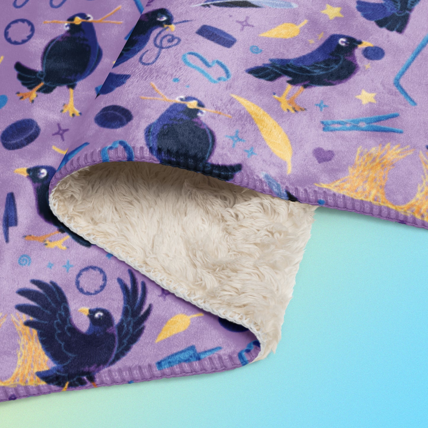 Close up detail of a folded purple, blue and yellow male Aussie satin bowerbird pattern blanket on a yellow and blue gradient background.