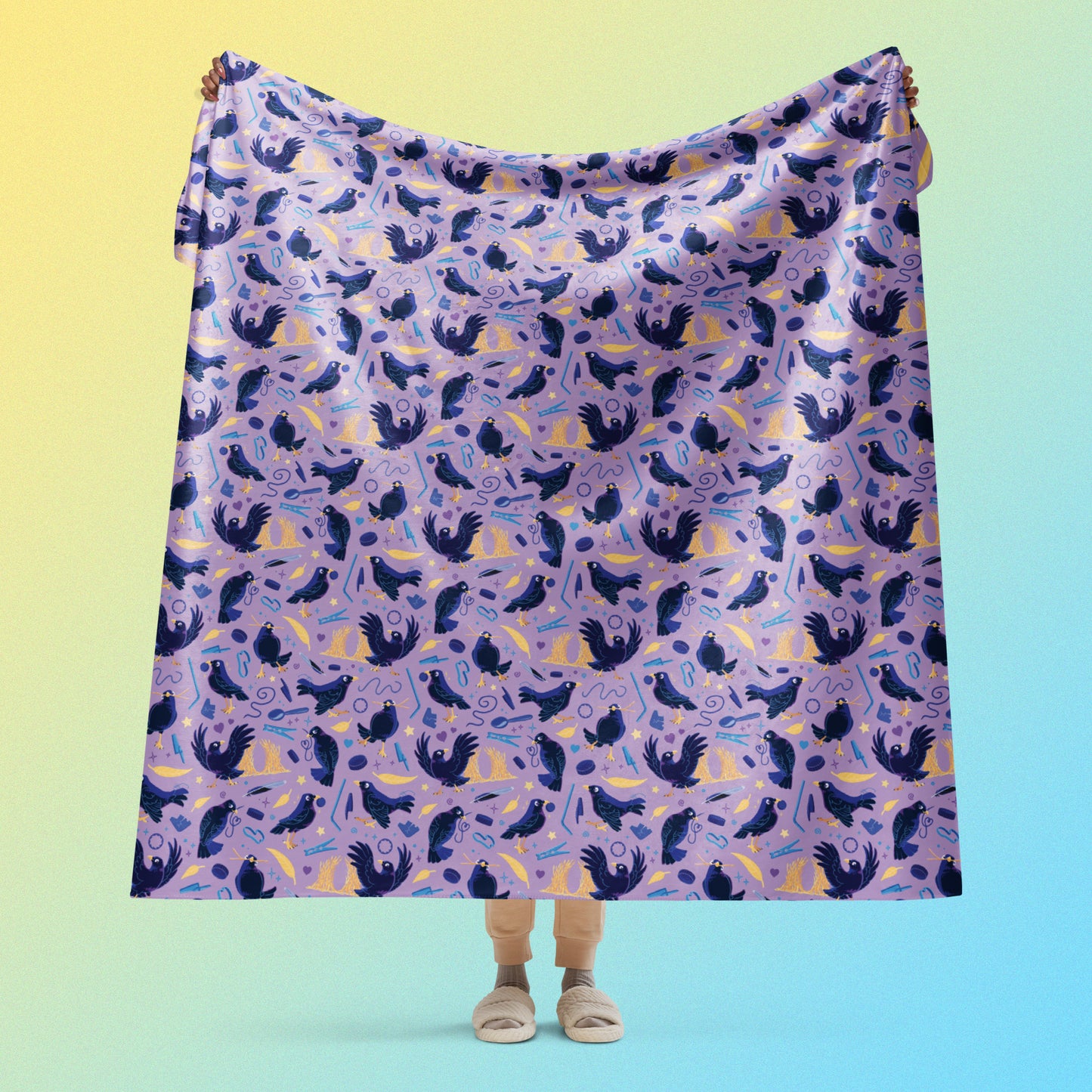 Person holding a purple, blue and yellow male Aussie satin bowerbird pattern blanket above their head on a yellow and blue gradient background.