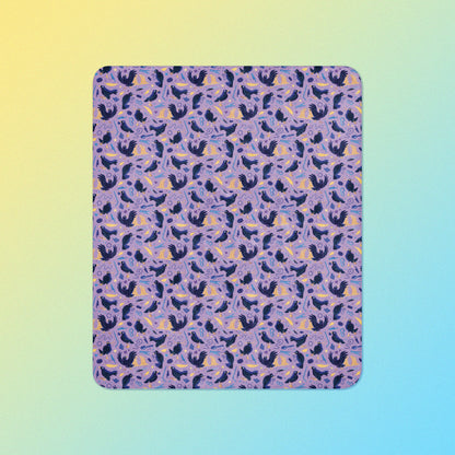 A purple, blue and yellow male Aussie satin bowerbird pattern blanket on a yellow and blue gradient background.