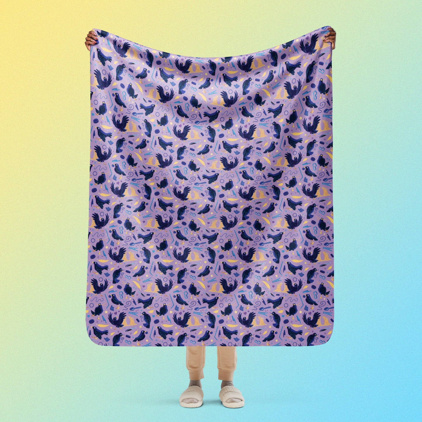 Person holding a purple, blue and yellow male Aussie satin bowerbird pattern blanket above their head on a yellow and blue gradient background.