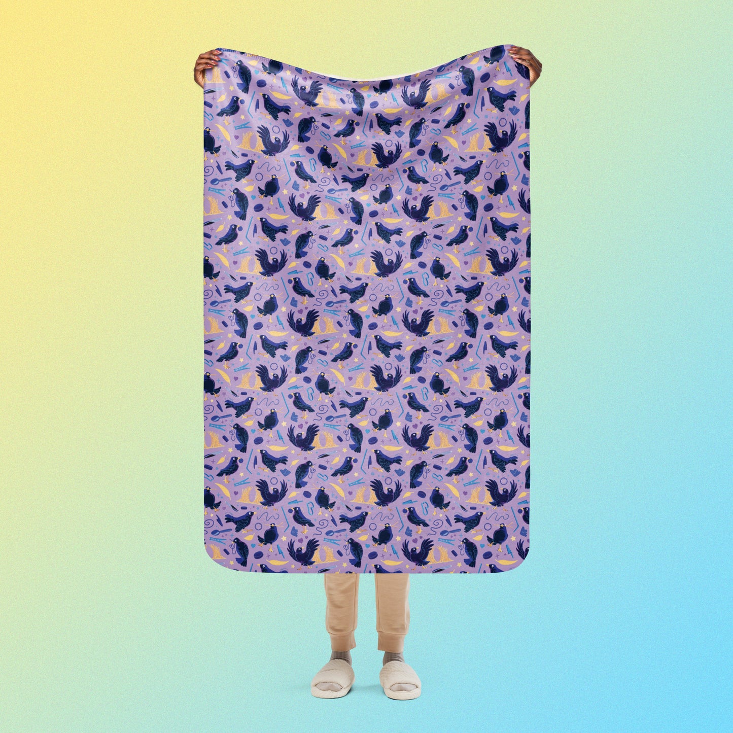 Person holding a purple, blue and yellow male Aussie satin bowerbird pattern blanket above their head on a yellow and blue gradient background.