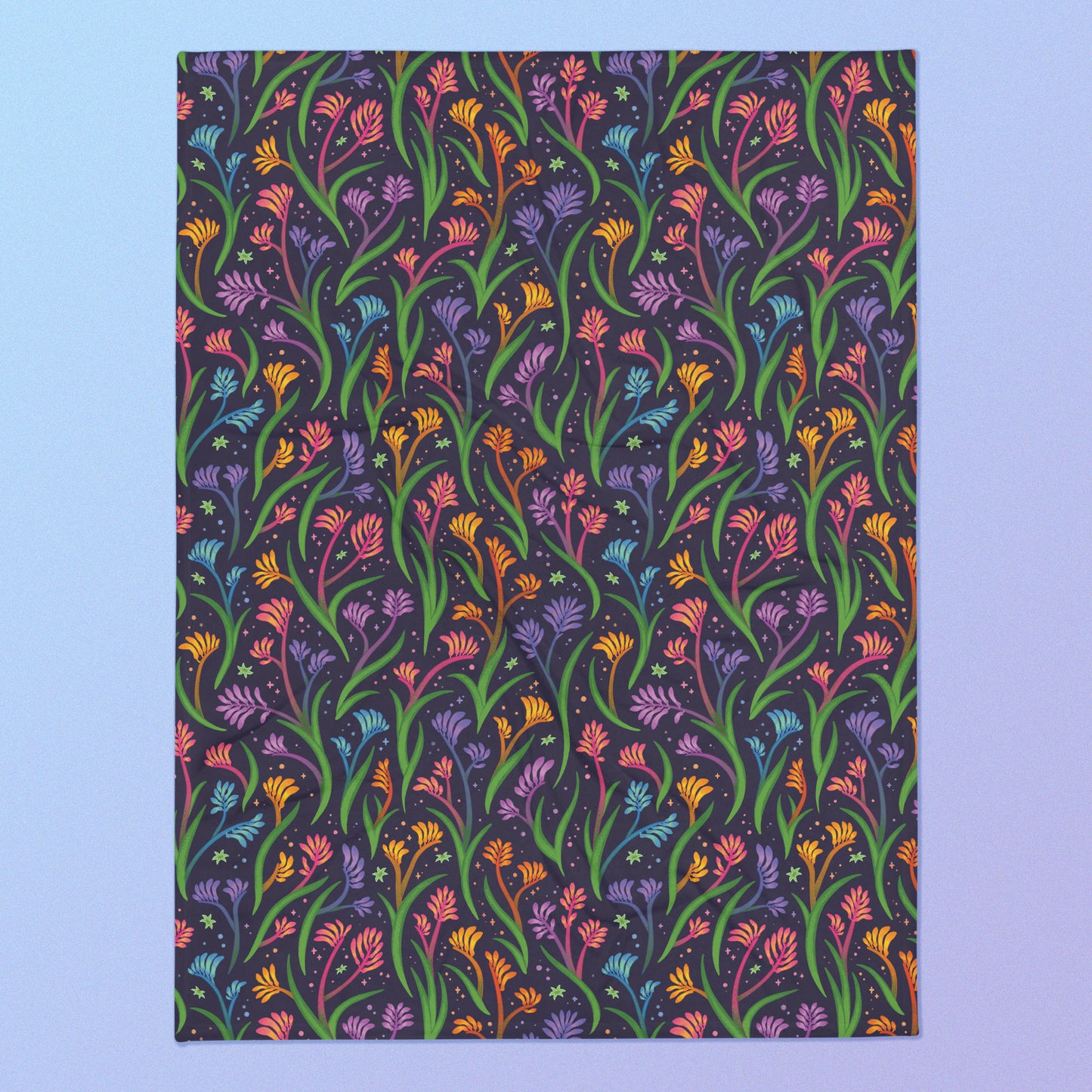 A rainbow kangaroo paw flower pattern blanket on a blue and purple gradient background.