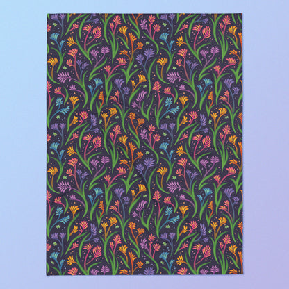 A rainbow kangaroo paw flower pattern blanket on a blue and purple gradient background.