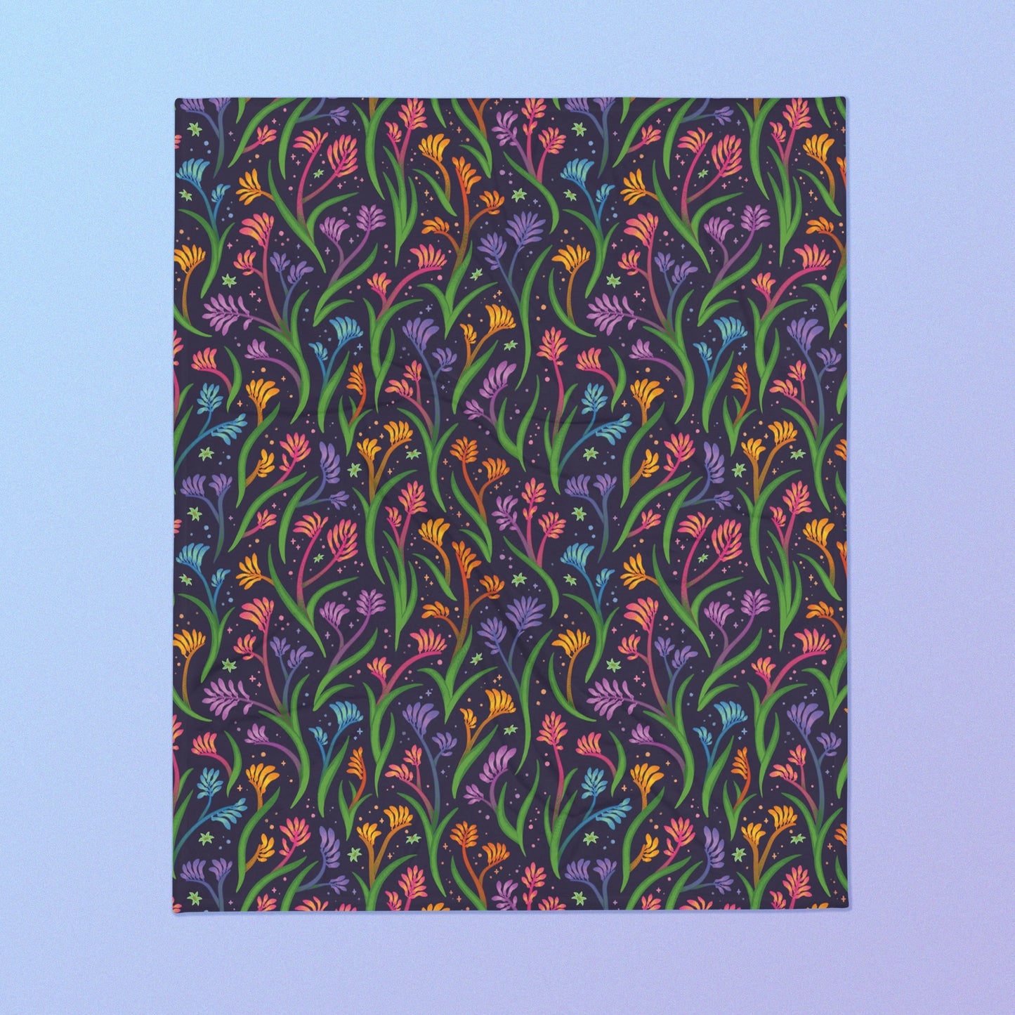 A rainbow kangaroo paw flower pattern blanket on a blue and purple gradient background.