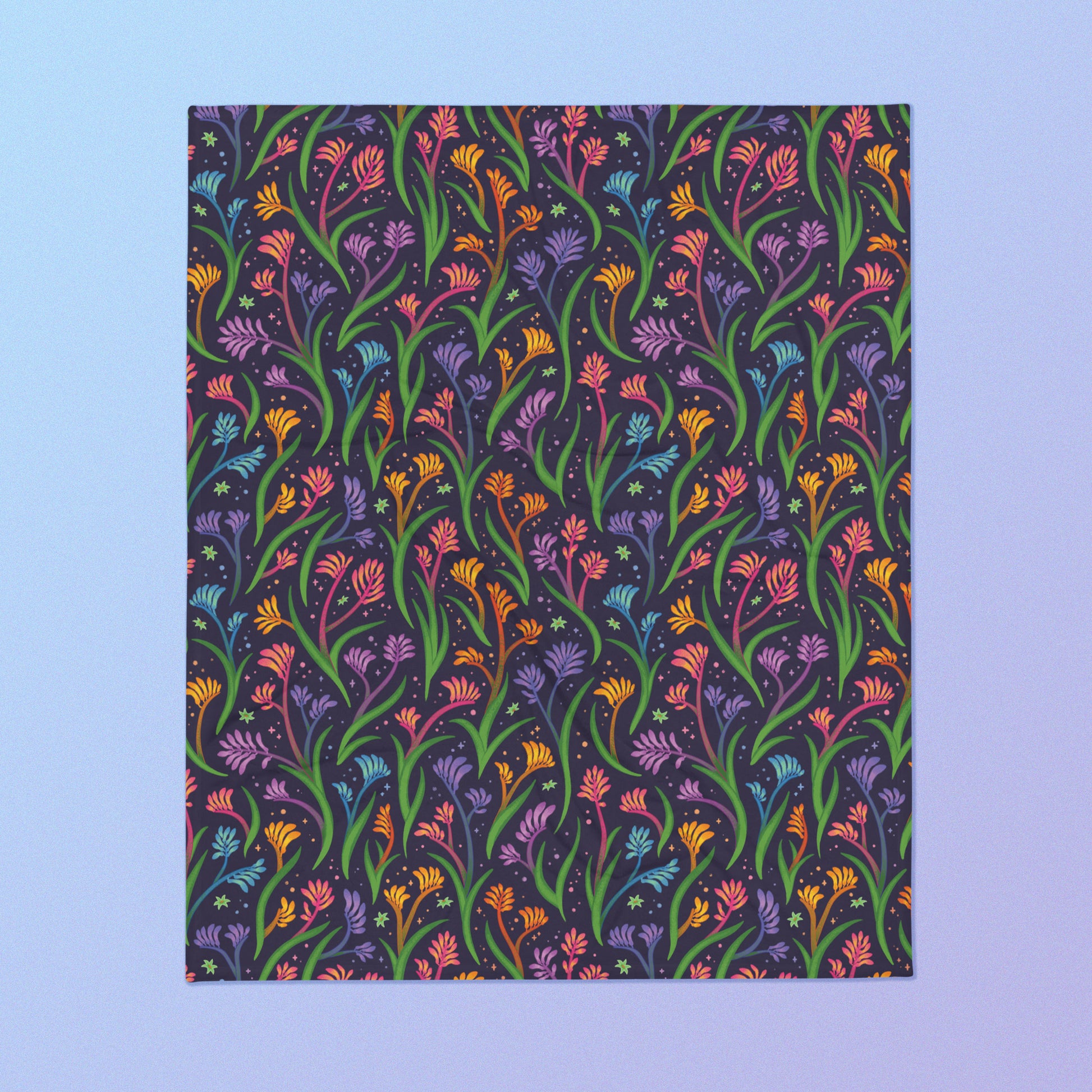 A rainbow kangaroo paw flower pattern blanket on a blue and purple gradient background.