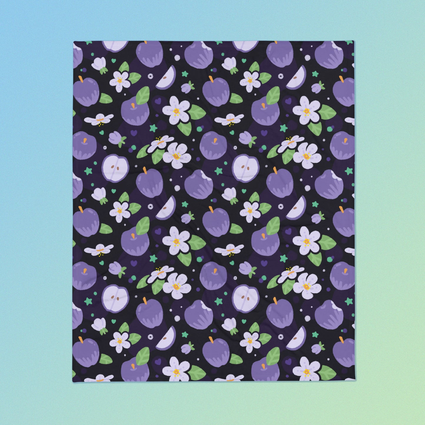 A purple apples & blossoms pattern blanket on a blue and green gradient background.