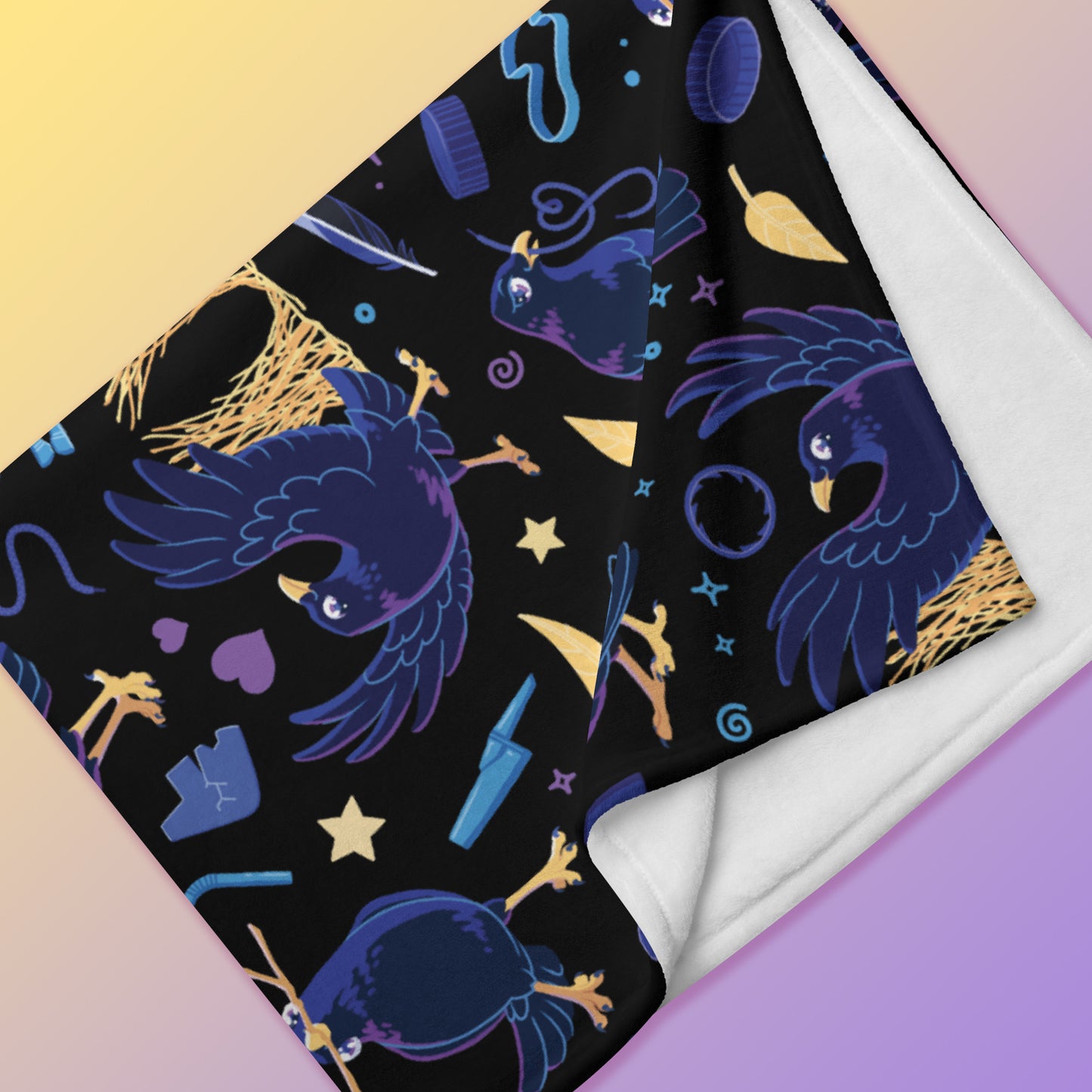 Close up detail of a folded black, blue, purple and yellow male Aussie satin bowerbird pattern blanket on a yellow and purple gradient background.
