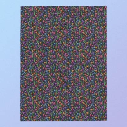 A rainbow kangaroo paw flower pattern blanket on a blue and purple gradient background.