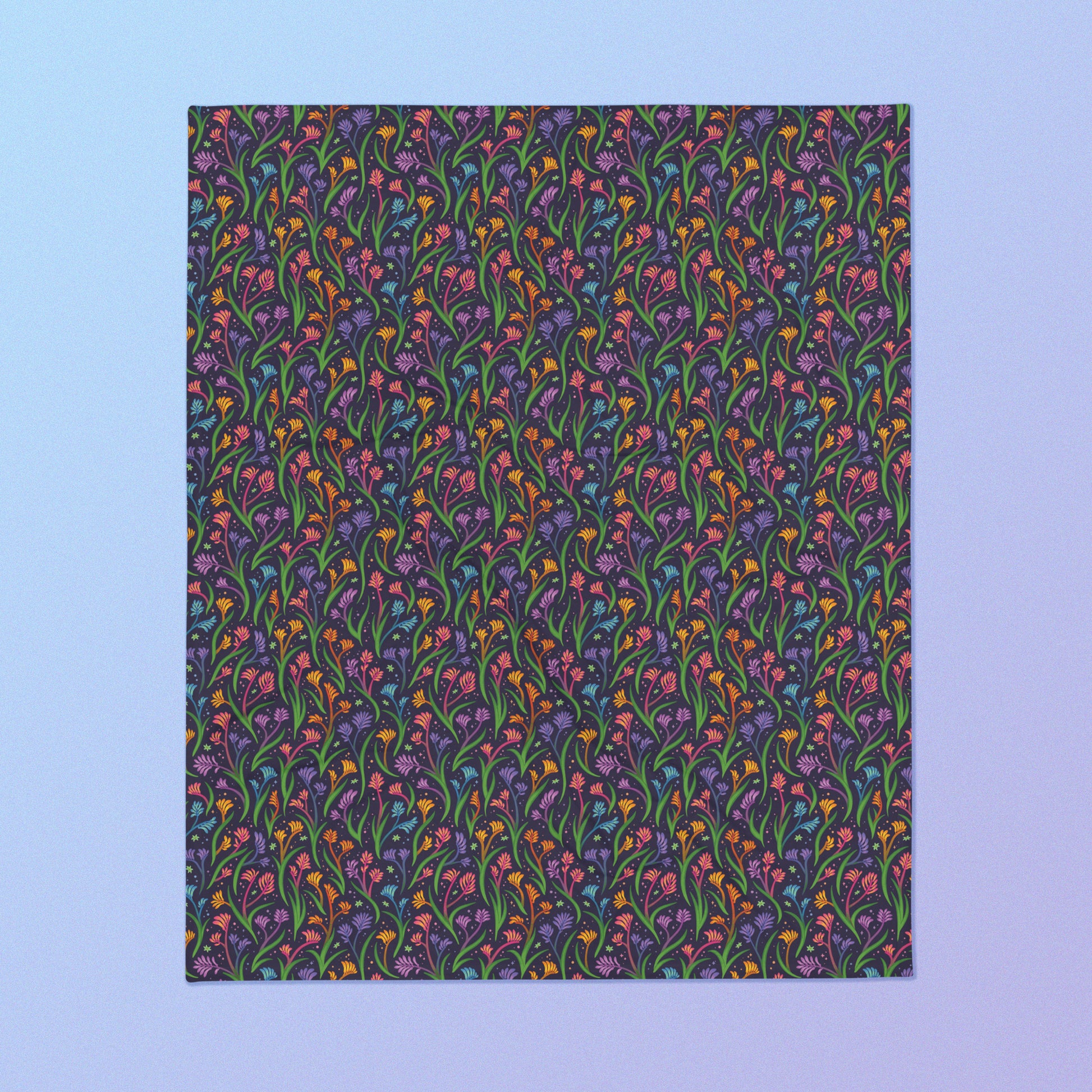 A rainbow kangaroo paw flower pattern blanket on a blue and purple gradient background.