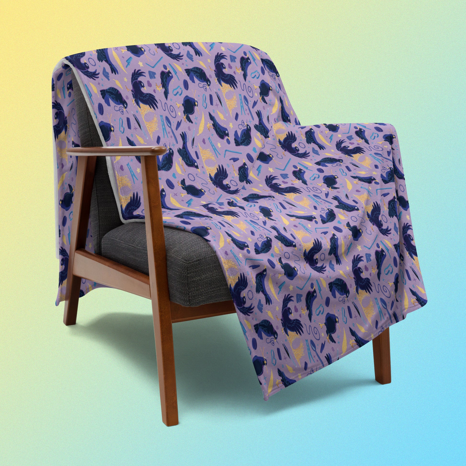 A purple, blue and yellow male Aussie satin bowerbird pattern blanket draped over a wooden chair on a yellow and blue gradient background.