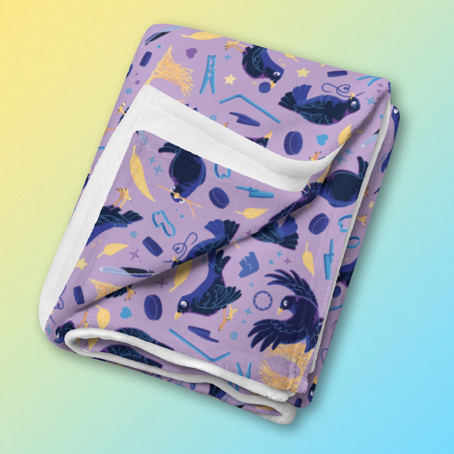A folded purple, blue and yellow male Aussie satin bowerbird pattern blanket on a yellow and blue gradient background.