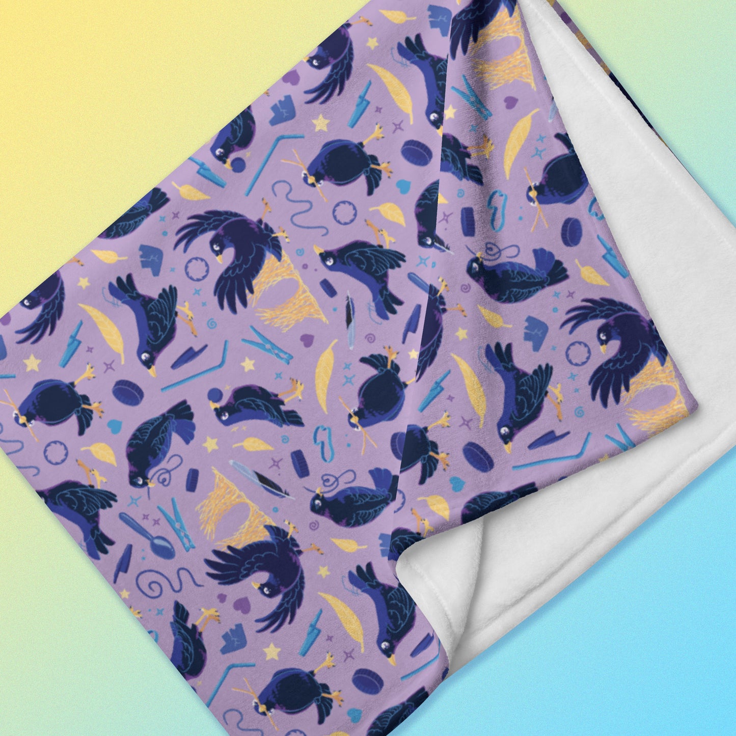 Detailed close up of a folded purple, blue and yellow male Aussie satin bowerbird pattern blanket on a yellow and blue gradient background.