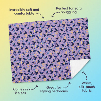 Features & benefits (Incredibly soft & comfortable', 'Perfect for sofa snuggling', 'Comes in 2 sizes', 'Great for styling bedrooms', 'Warm silk-touch fabric') surrounding a purple, blue and yellow male Aussie satin bowerbird pattern blanket on a yellow and blue gradient background.