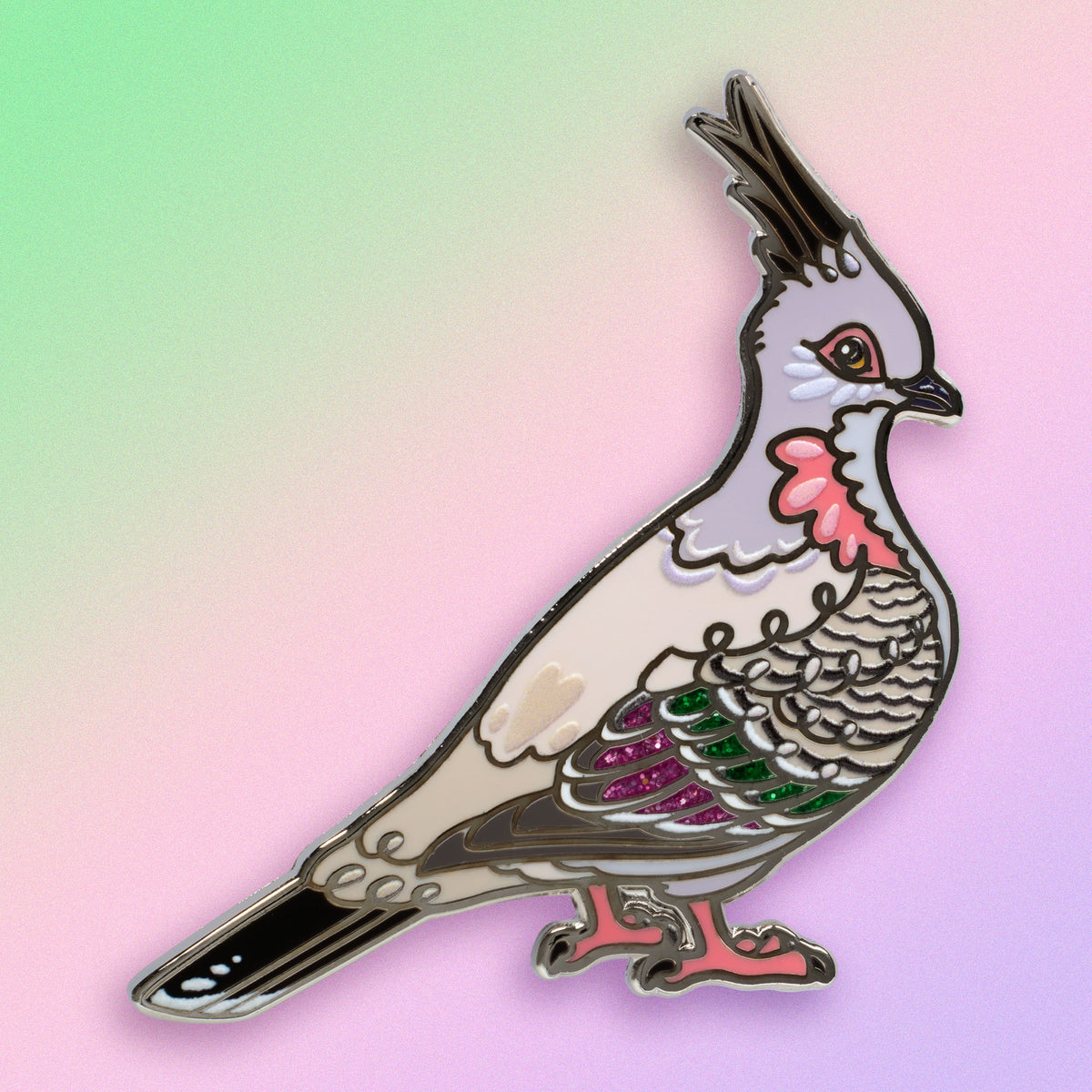 A nickel-plated crested pigeon hard enamel pin on a green, purple and pink gradient background.