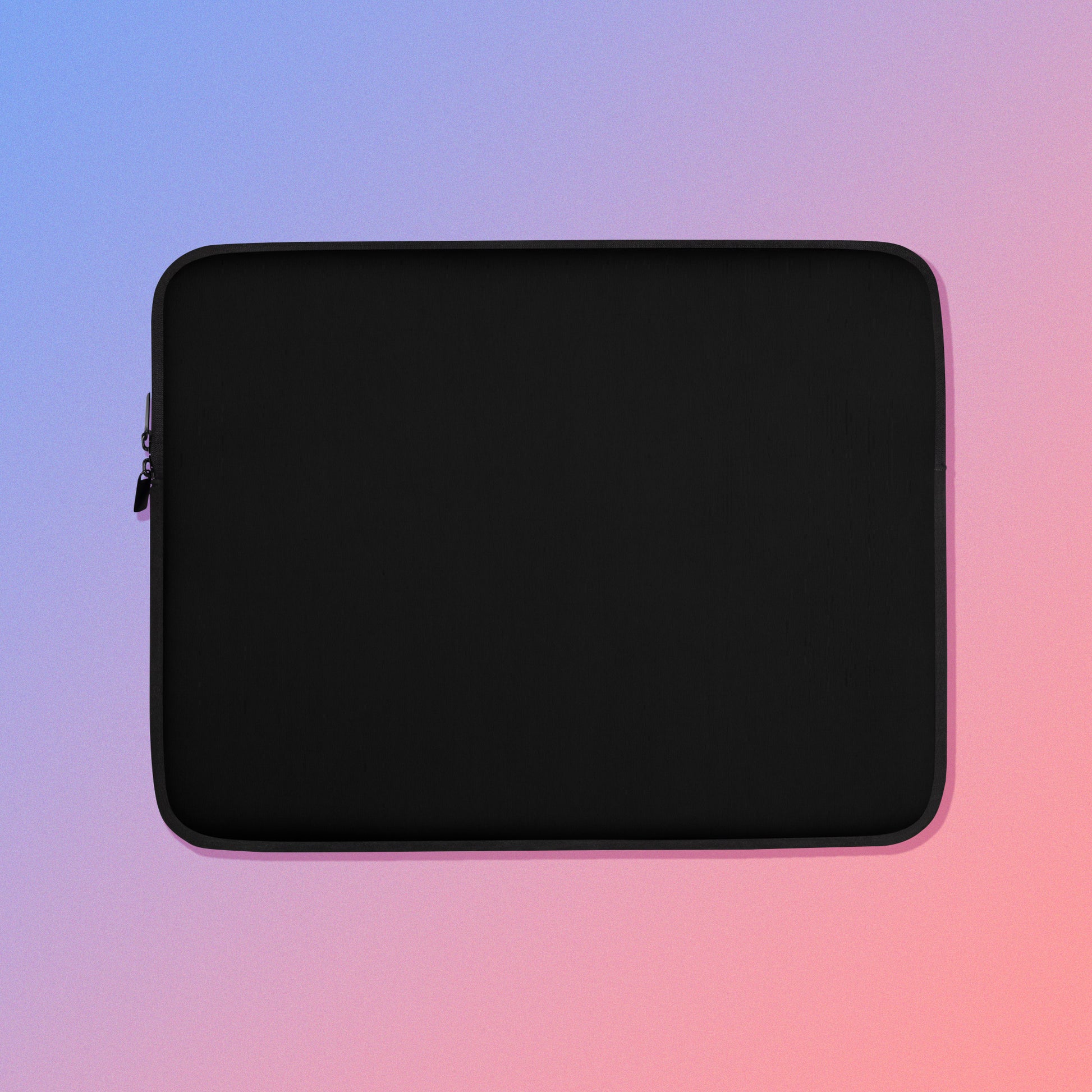 Laptop sleeve with plain black fabric on one side and a colourful green, red, blue and pink crimson rosella pattern on the other on a pink and blue gradient background.