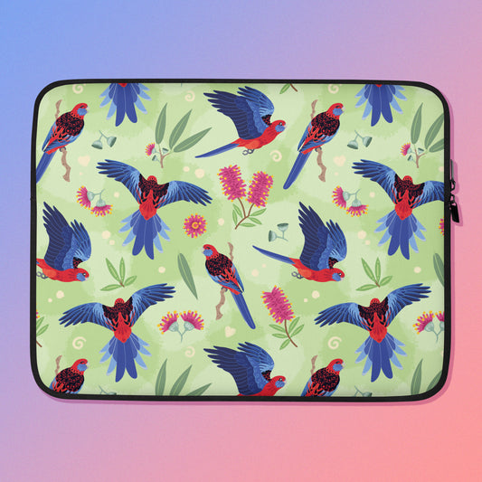 Laptop sleeve with a colourful green, red, blue and pink crimson rosella pattern on a pink and blue gradient background.