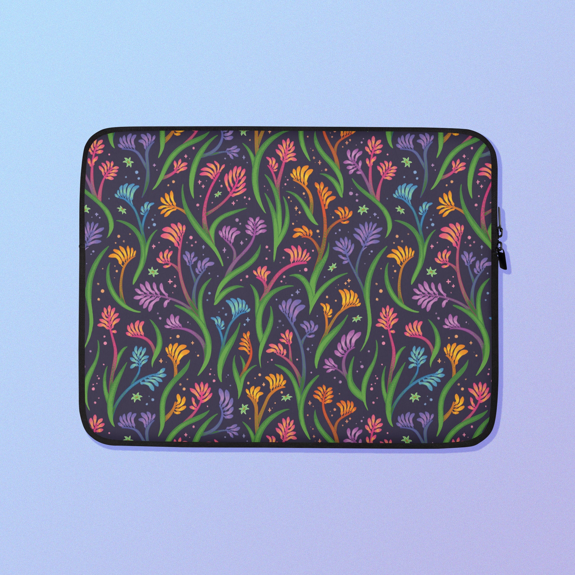 Laptop sleeve with a colourful rainbow kangaroo paw flower pattern on a blue and purple gradient background.