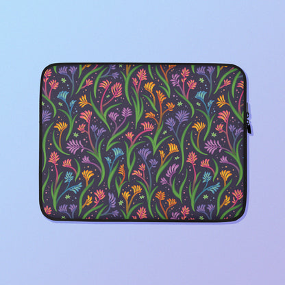 Laptop sleeve with a colourful rainbow kangaroo paw flower pattern on a blue and purple gradient background.