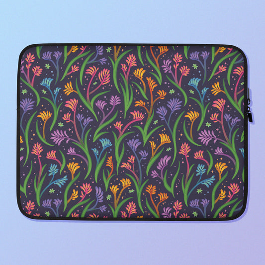 Laptop sleeve with a colourful rainbow kangaroo paw flower pattern on a blue and purple gradient background.