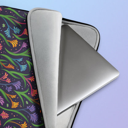 Close up detail of a laptop sitting in a laptop sleeve with a colourful rainbow kangaroo paw flower pattern on a blue and purple gradient background.