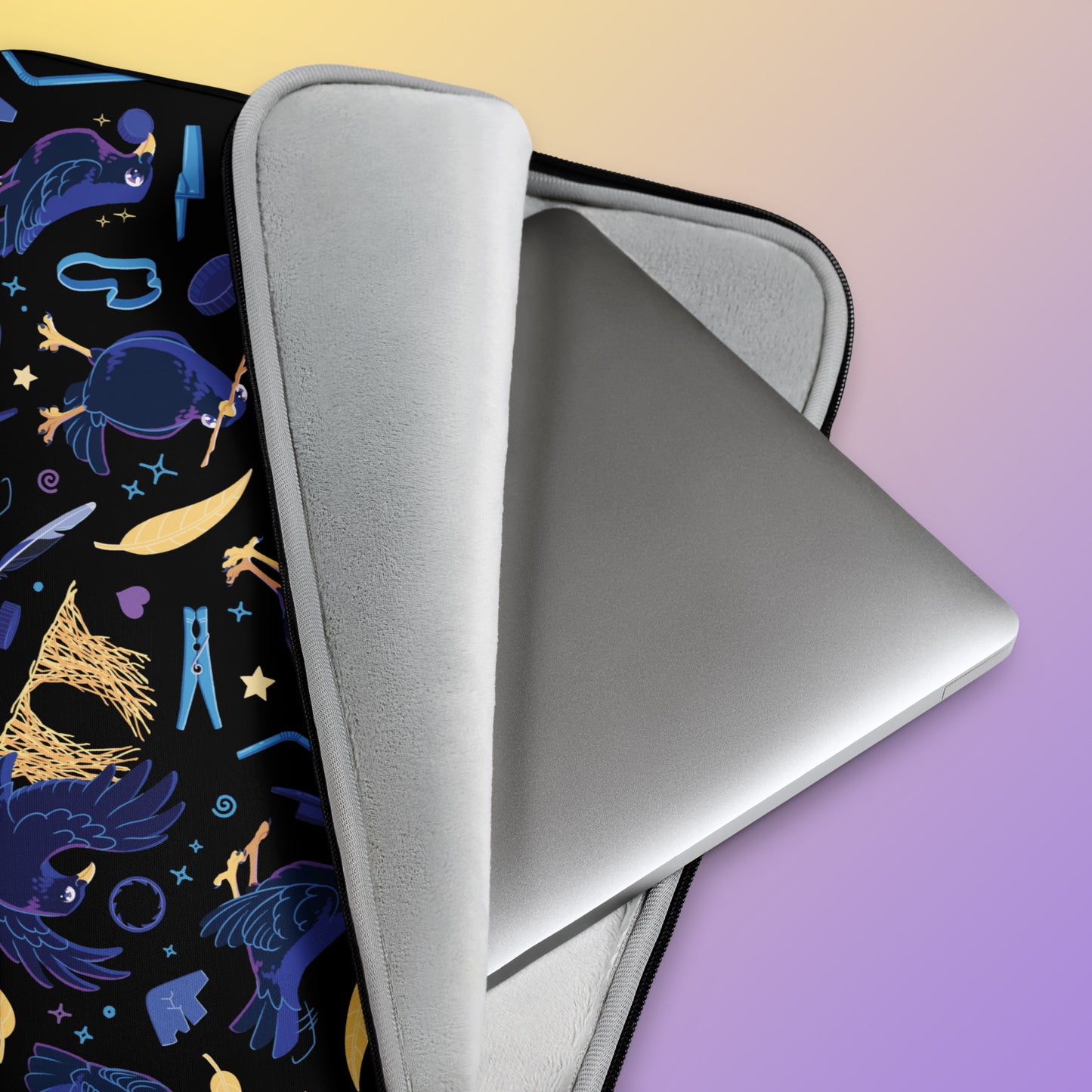 Close up detail of a laptop sitting in a laptop sleeve with a colourful purple, blue and yellow satin bowerbird pattern on a yellow and purple gradient background.