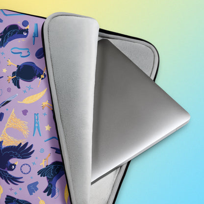 Close up detail of a laptop sitting in a laptop sleeve with a colourful purple, blue and yellow satin bowerbird pattern on a yellow and blue gradient background.
